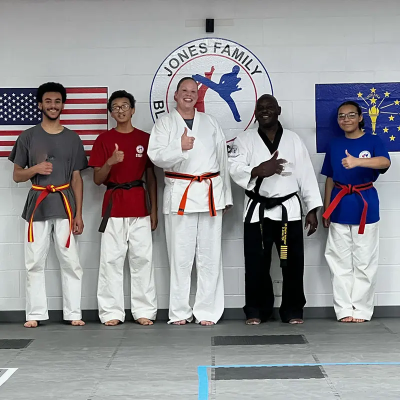 Adult MMA students relaxing and socializing after training in Evansville gym